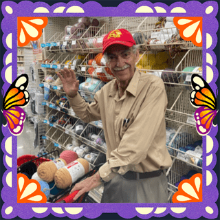 Photo of Eduardo Bustos (Grandpa Lalo) in an illustrated frame of purple papel picado, with monarch butterfly wings.
