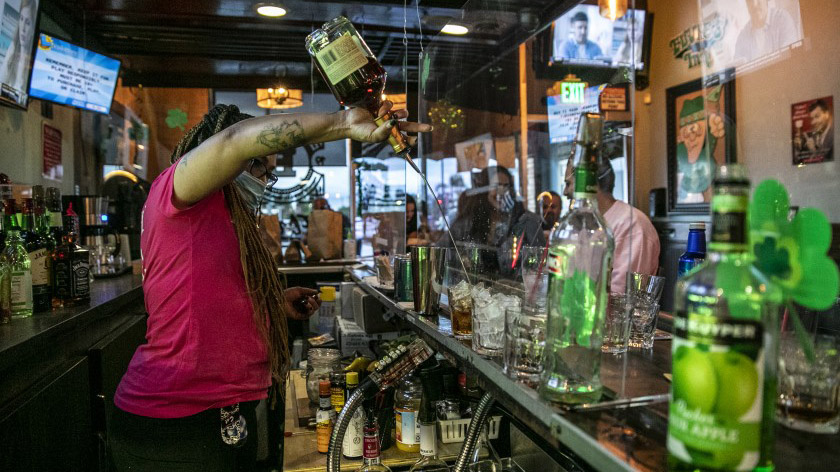 A bartender in Covina serves drinks for customers in June. (Robert Gauthier / Los Angeles Times)