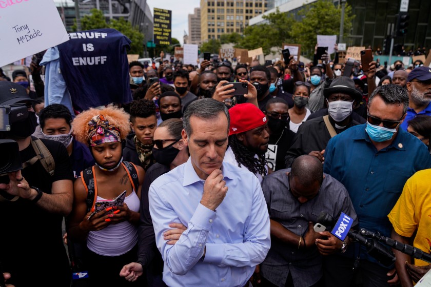 L.A. Mayor Eric Garcetti stands with demonstrators during a peaceful protest outside City Hall. (Kent Nishimura / Los Angeles Times)