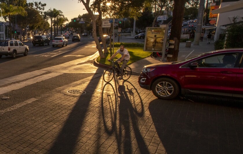 People on bikes ride in the bike lane in West hollywood.