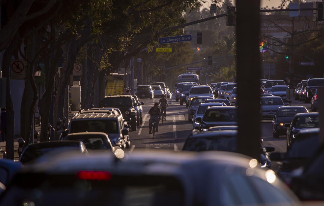 People on bikes ride in the bike lane in West hollywood.