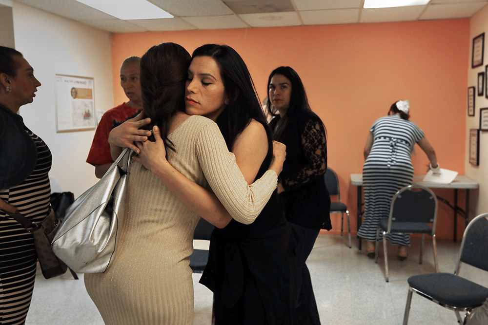 Luxia Gomez hugs another woman goodbye at the end of a Trangéneros Unidas meeting.
