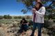 Hoskie and his sister, Johnelle, pick wildflowers with sweet nectar near their hogan on the Navajo Nation.