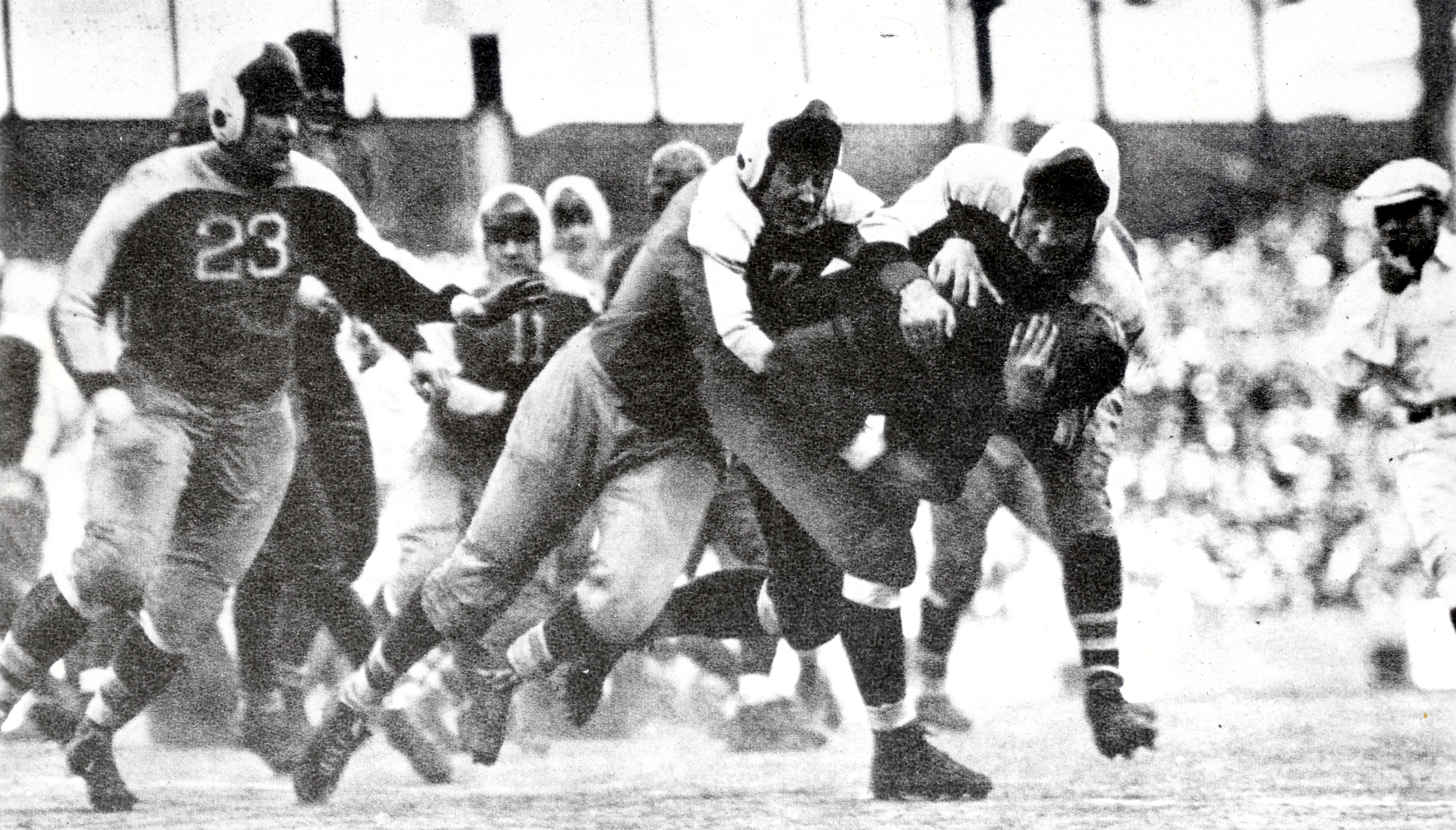 Chicago Bears fullback Bronko Nagurski is tackle by the New York Giants' Mel Hein in the 1934 NFL title game at the Polo Grounds in New York.