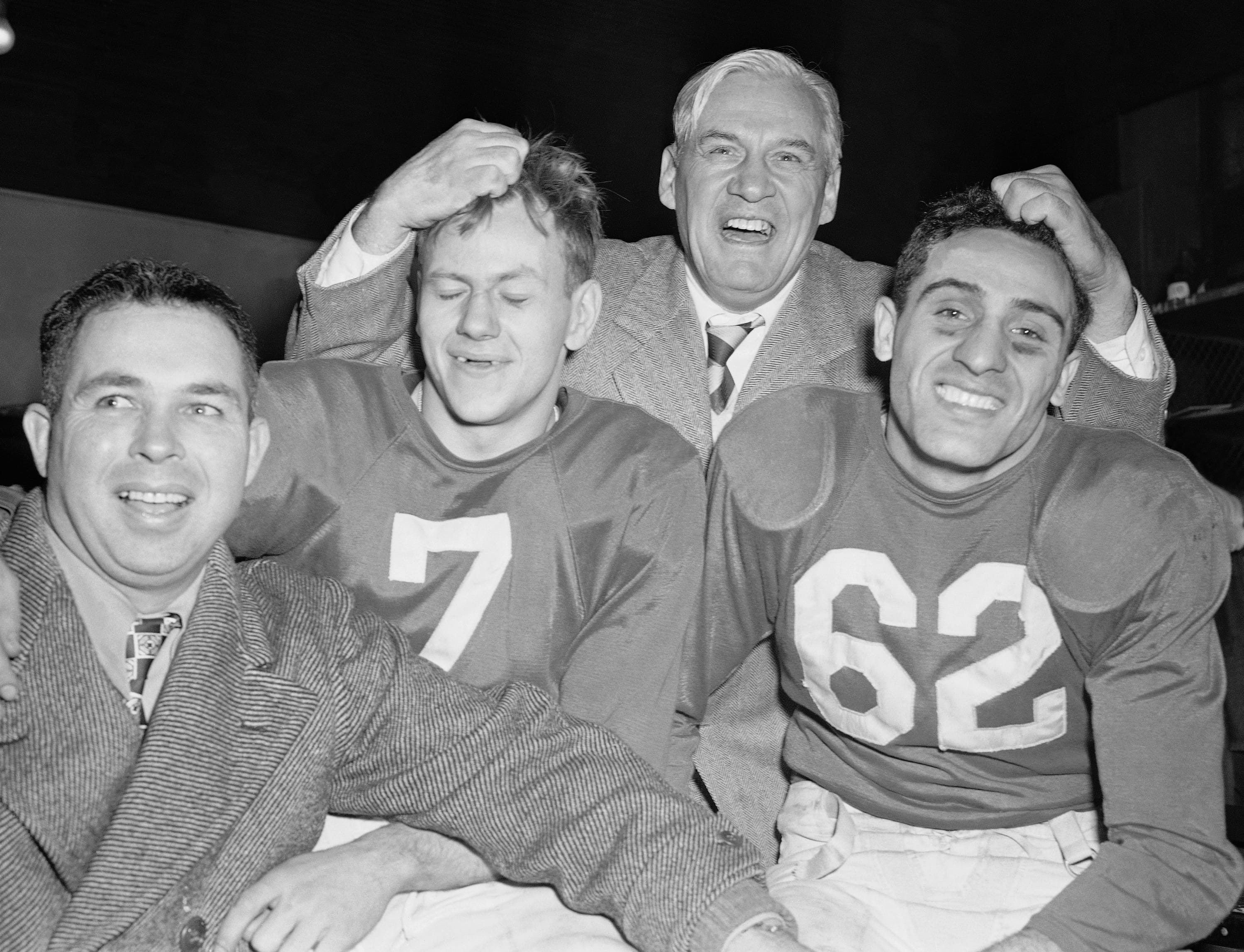 Chicago Cardinals coach Jimmy Conzelman, center, celebrates with assistant coach Phil Handler and running backs Charley Trippi and Elmer Angsman after beating the Philadelphia Eagles in the 1947 NFL title game.