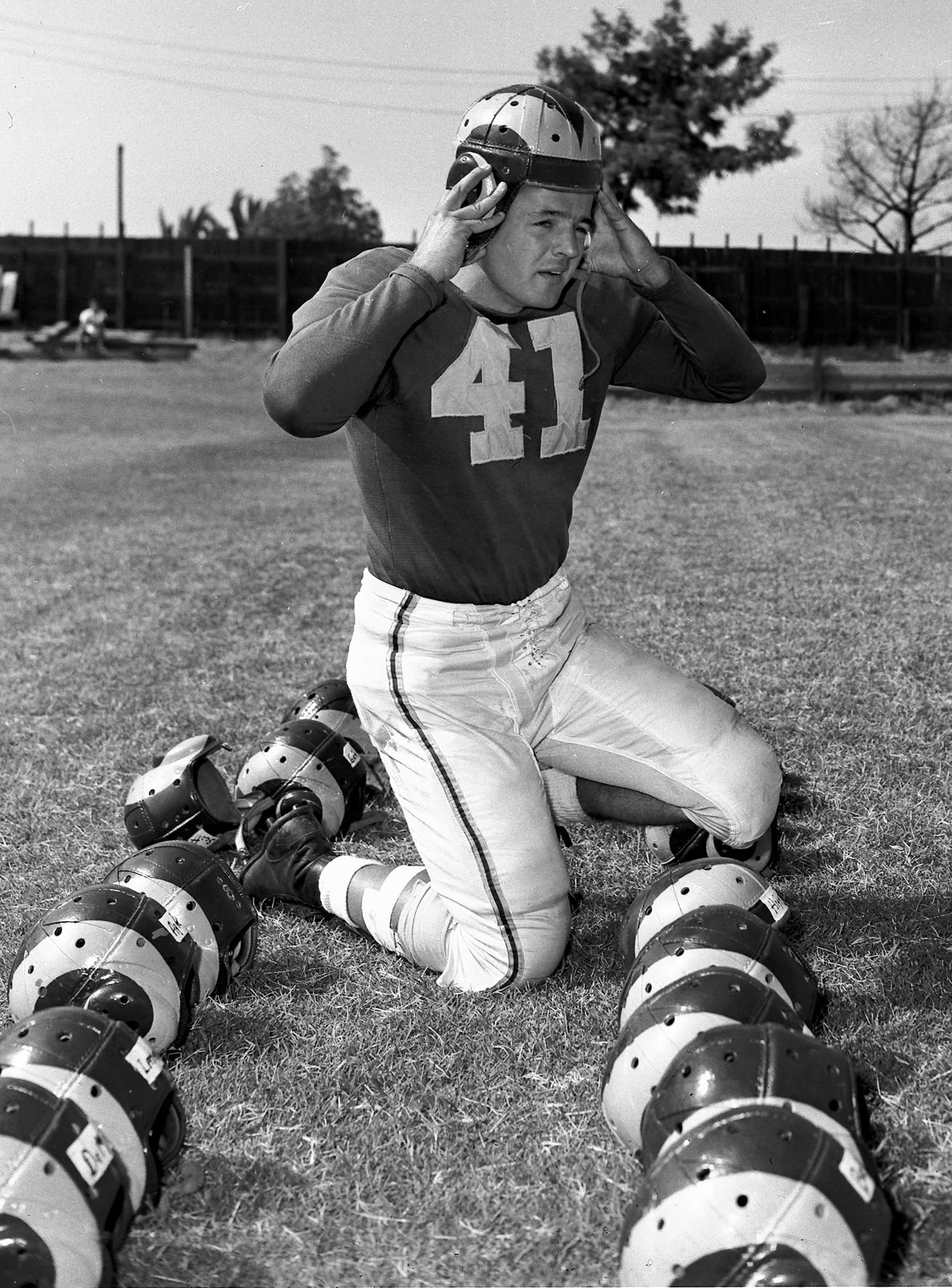Heisman Trophy winner Glenn Davis tries on a Rams helmet prior to a team workout in August 1948.