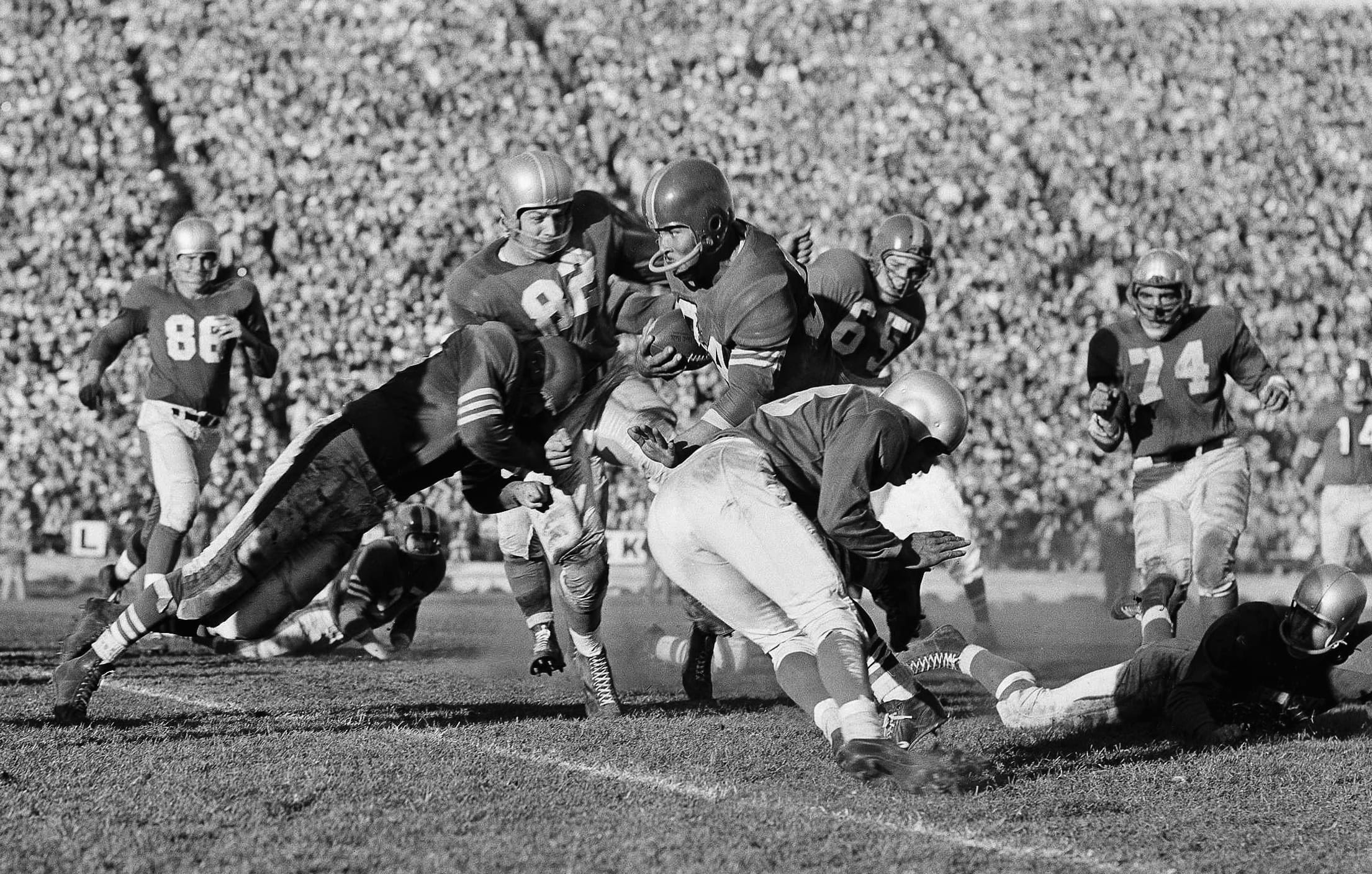 San Francisco 49ers fullback Joe Perry carries the ball against the Detroit Lions.
