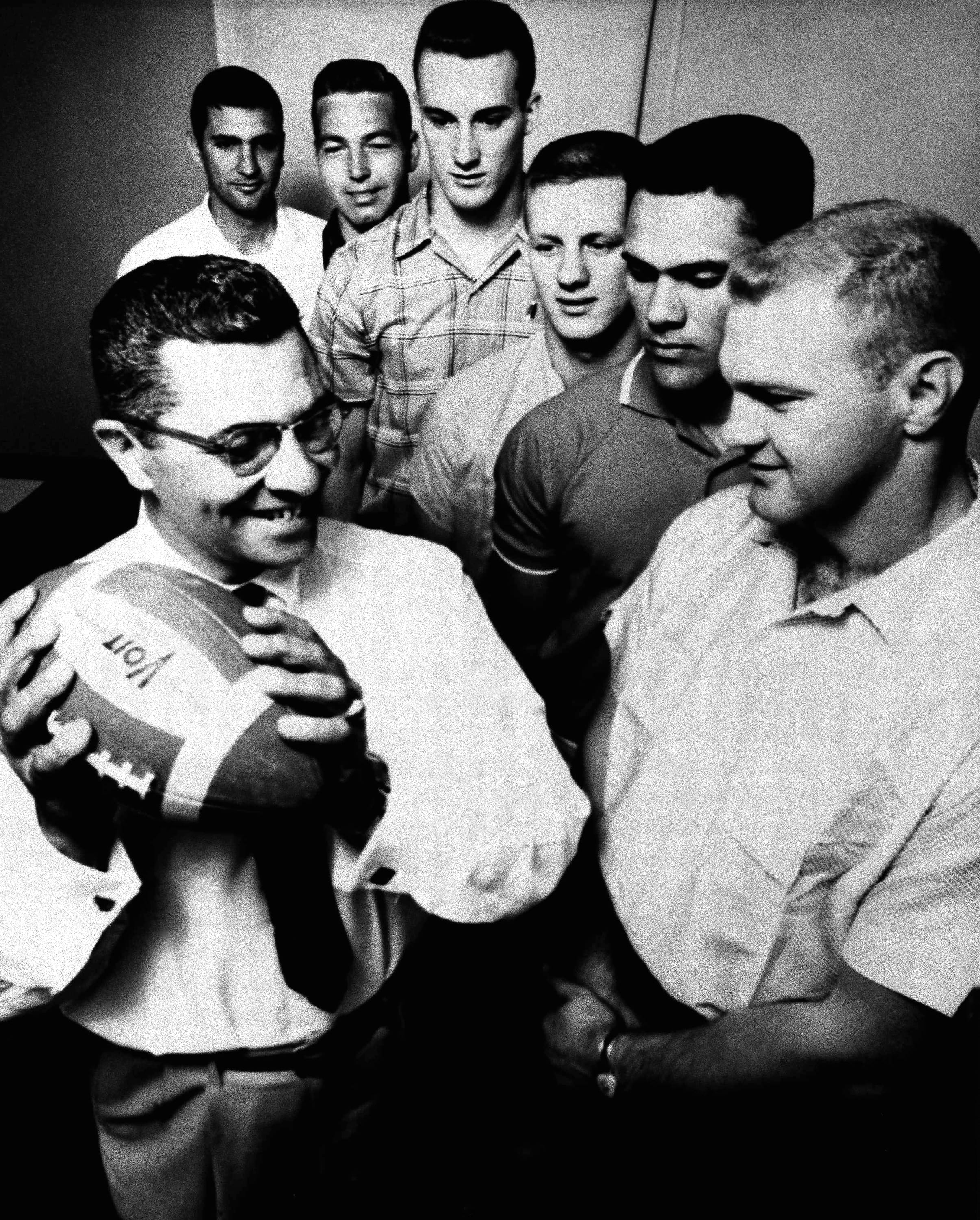 Vince Lombardi smiles while standing next to potential Green Bay Packers quarterback candidates in 1959.