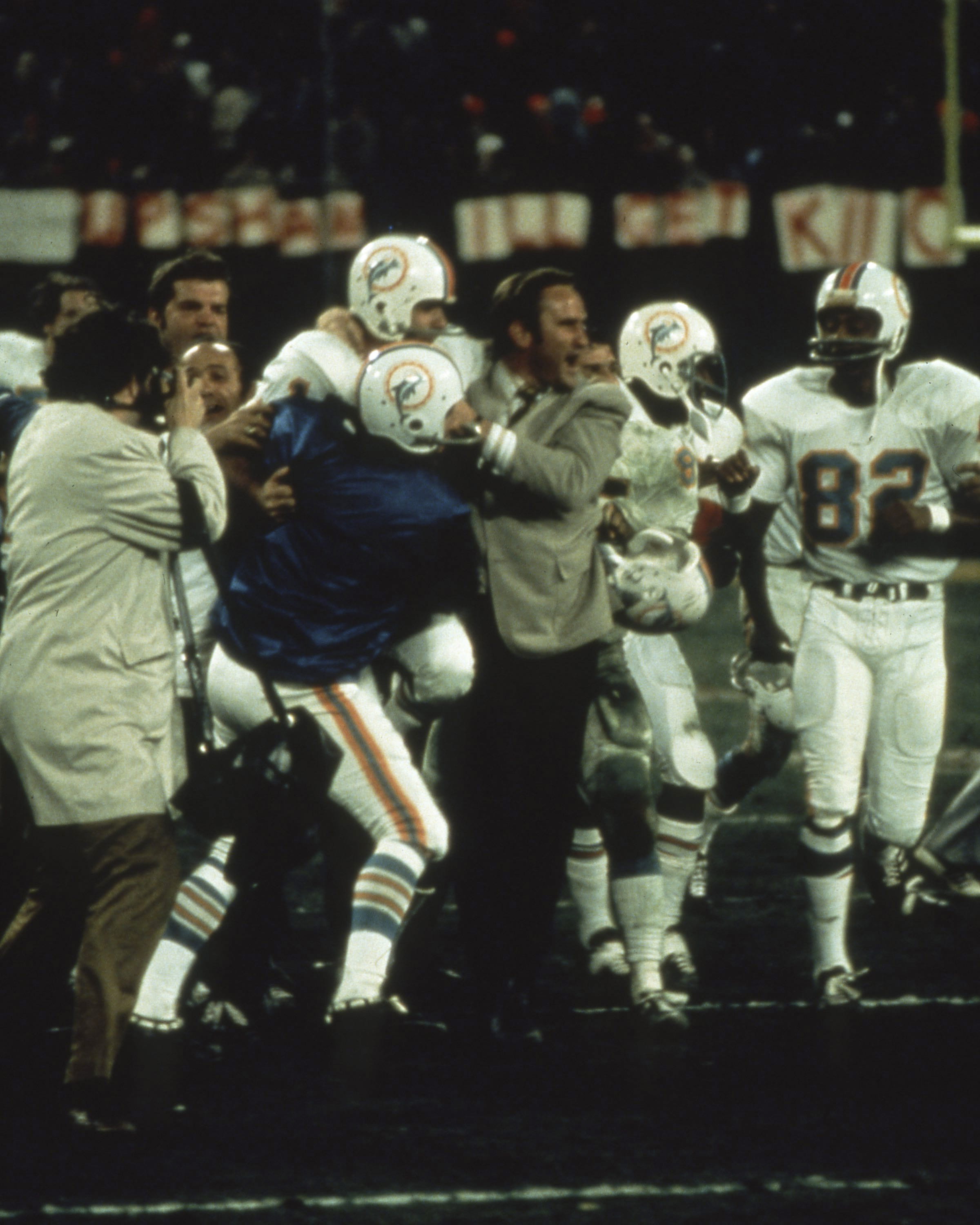 Miami Dolphins coach Don Shula celebrates with players after a double-overtime playoff victory over the Kansas City Chiefs.