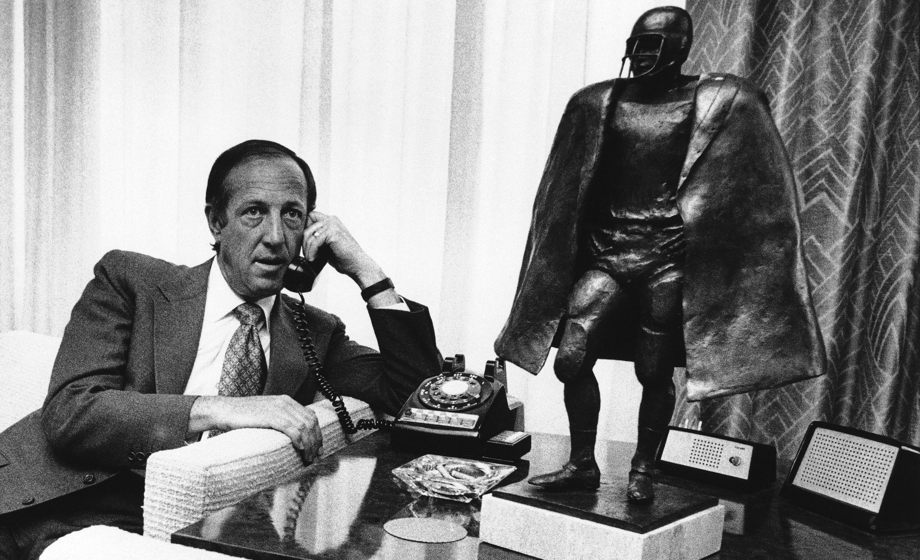 NFL commissioner Pete Rozelle talks on the phone in his New York office in March 1974.