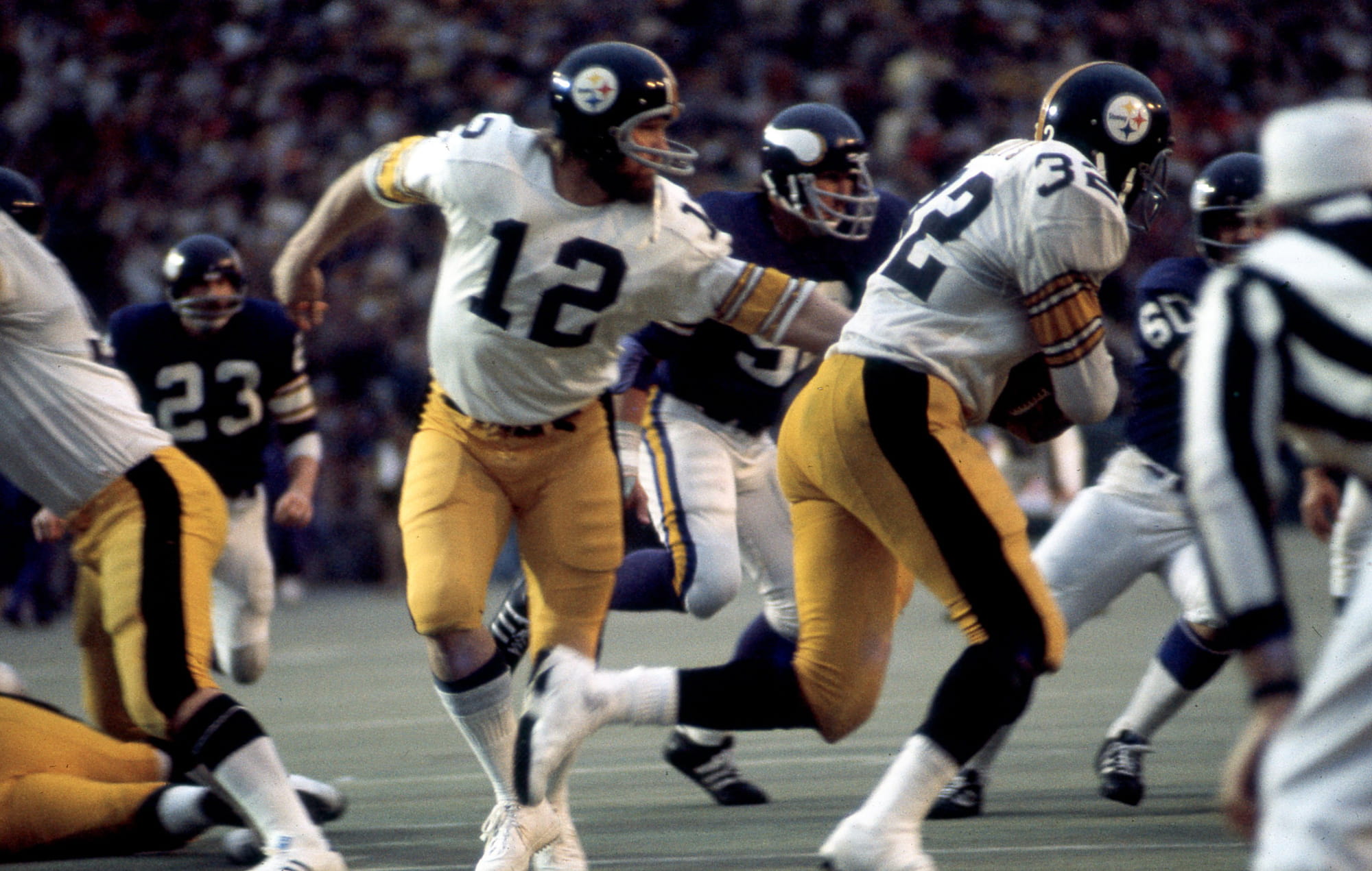 Pittsburgh Steelers quarterback Terry Bradshaw hands off to fullback Franco Harris during Super Bowl IX.