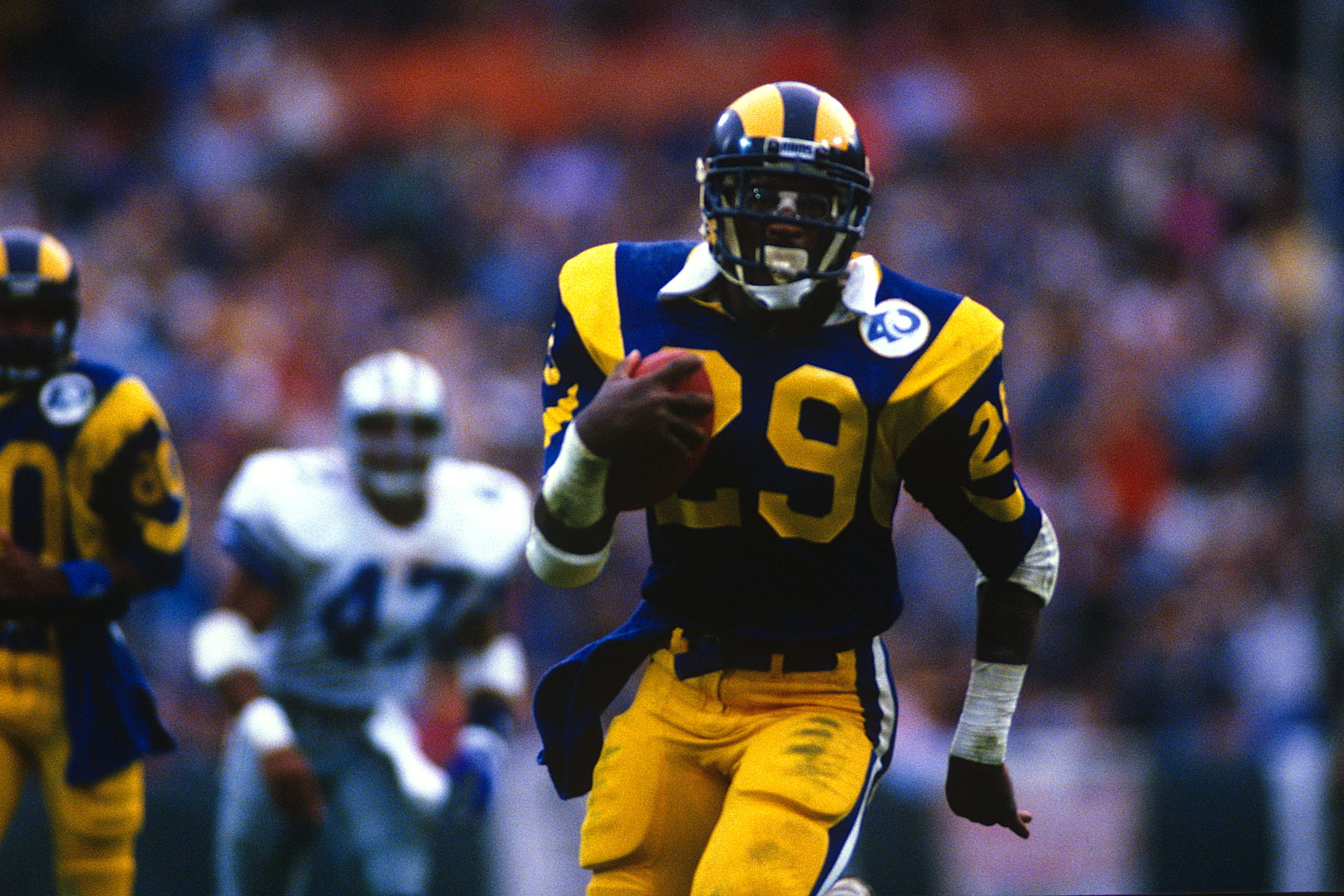 Los Angeles Rams running back Eric Dickerson carries the ball during a playoff game against the Dallas Cowboys in 1986.