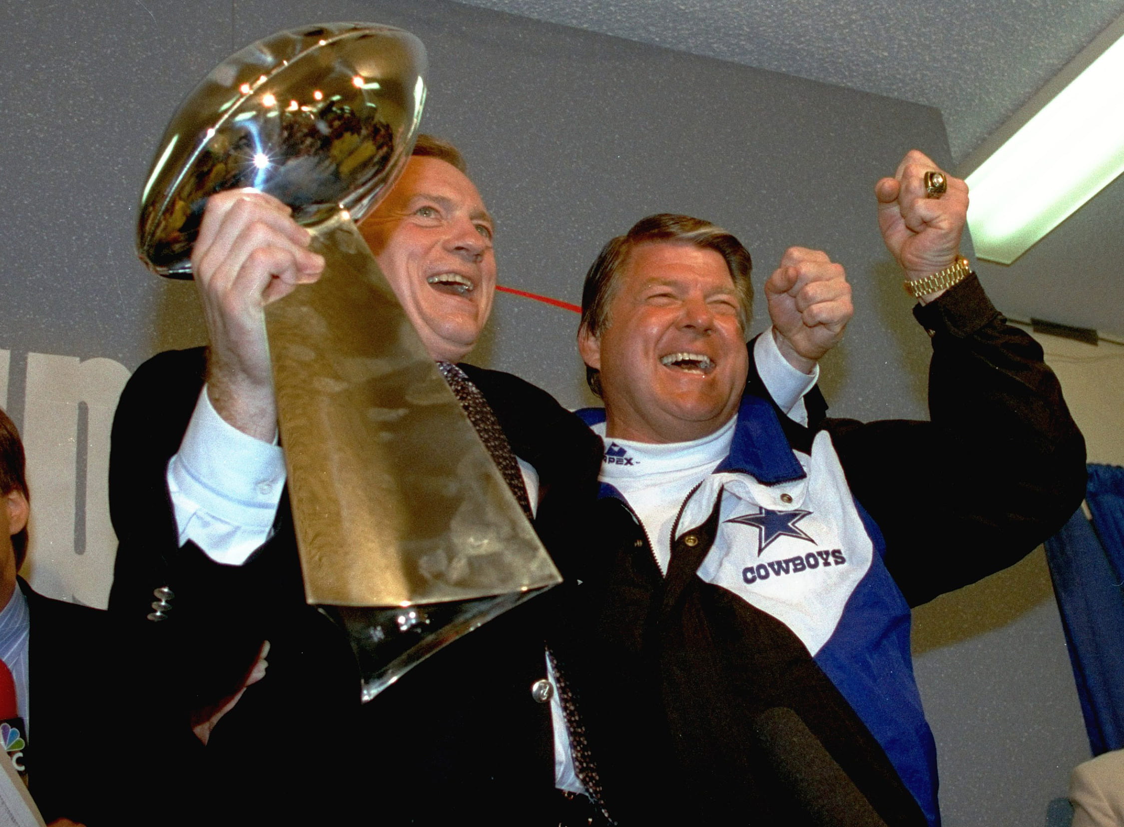 Dallas Cowboys owner Jerry Jones, left, and coach Jimmy Johnson celebrate with the Vince Lombardi Trophy after defeating the Buffalo Bills in Super Bowl XXVII.