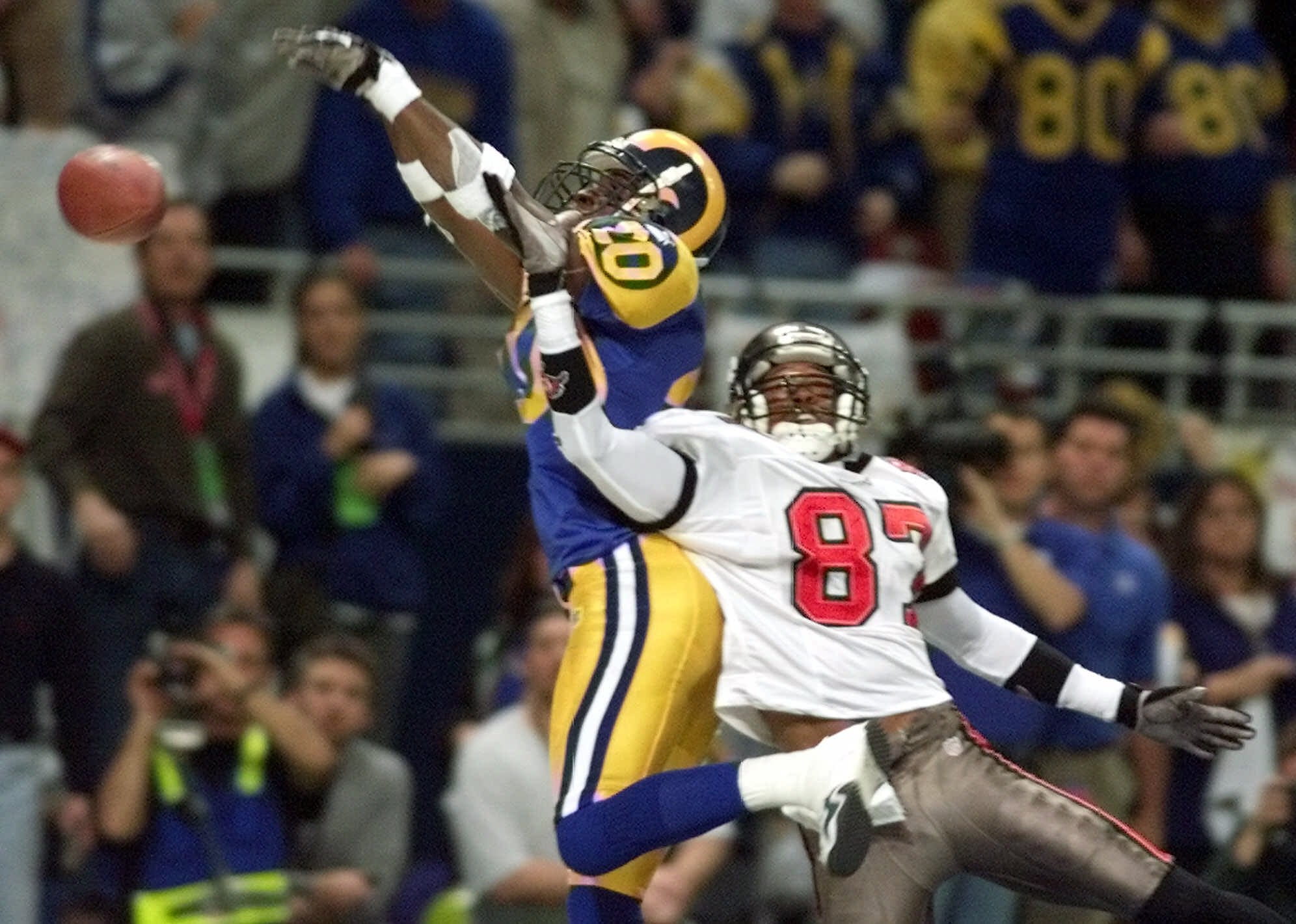 Tampa Bay wide receiver Bert Emanuel jumps over St. Louis Rams cornerback Taje Allen to make a catch that was later overturned during the NFC championship game for the 1999 season.