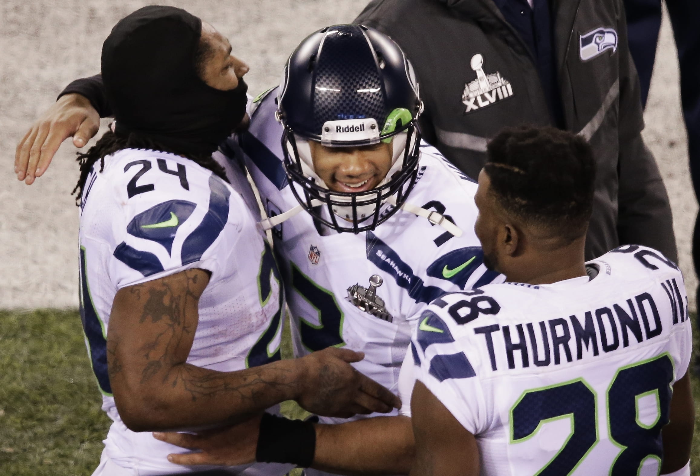 Seattle Seahawks teammates Russell Wilson, center, Marshawn Lynch, left, and Walter Thurmond celebrate their Super Bowl XLVIII victory over the Denver Broncos.