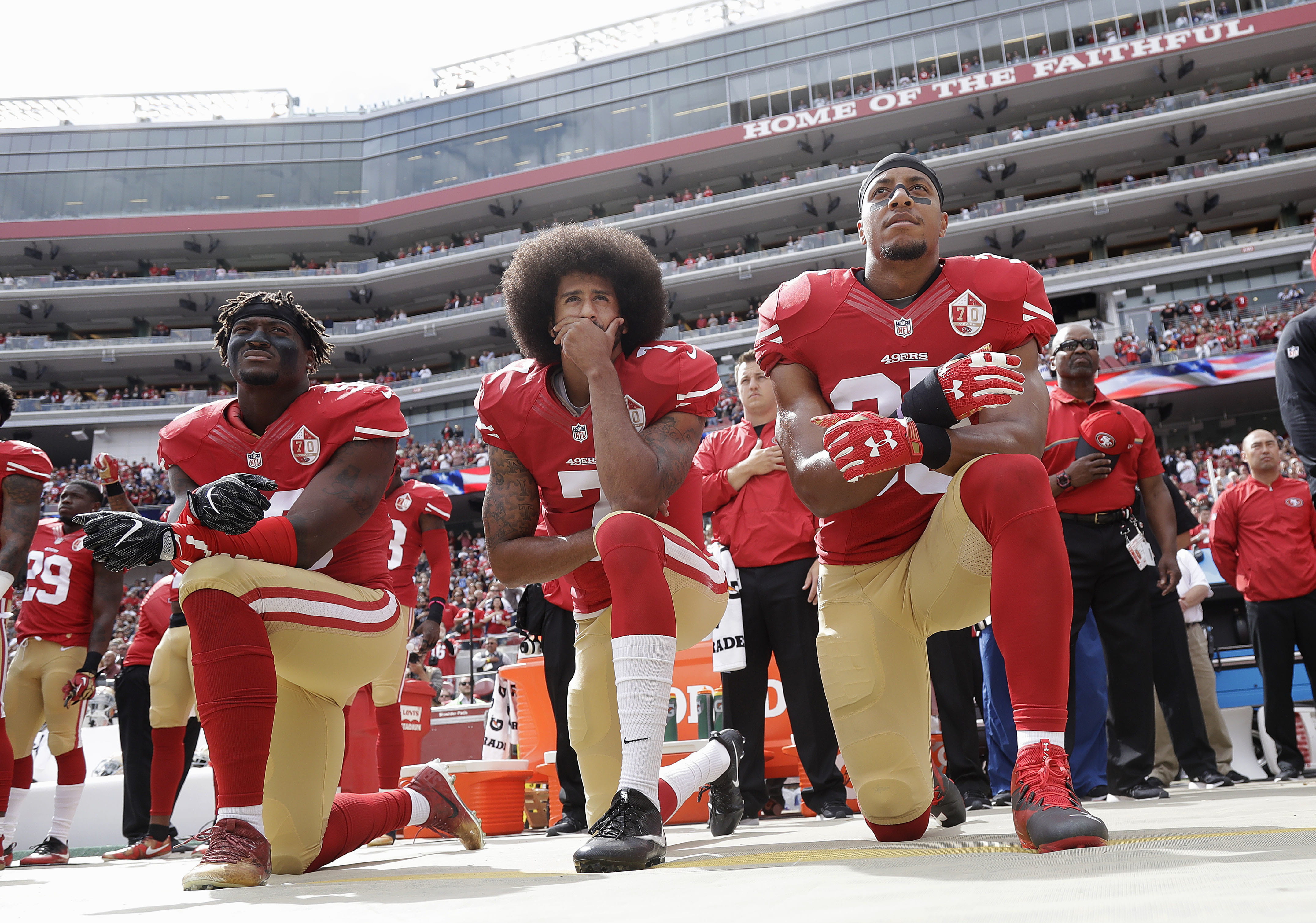 San Francisco 49ers teammates (from left) Eli Harold, Colin Kaepernick and Eric Reid kneel during the national anthem before a game against the Dallas Cowboys in October 2016.