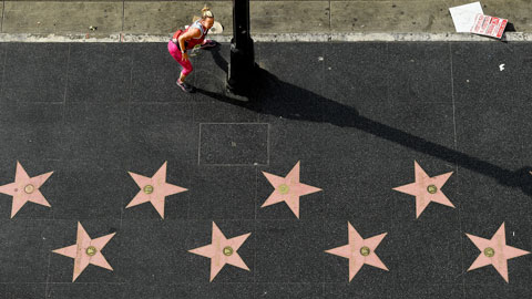 Woman stretches on Hollywood Walk of Fame
