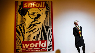 A Barbara Kruger piece hanging behind Helen Molesworth at the MOCA. (Jay L. Clendenin / Los Angeles Times)