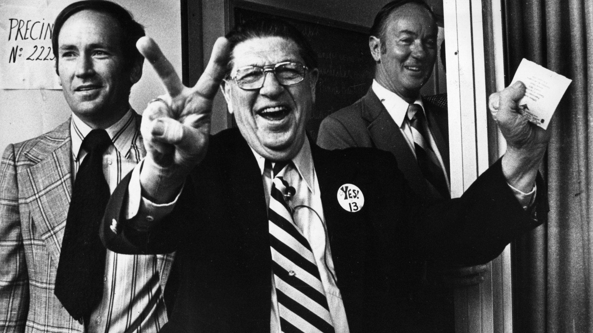 Howard Jarvis signals victory for Proposition 13 as he casts his ballot in Los Angeles on June 6, 1978.