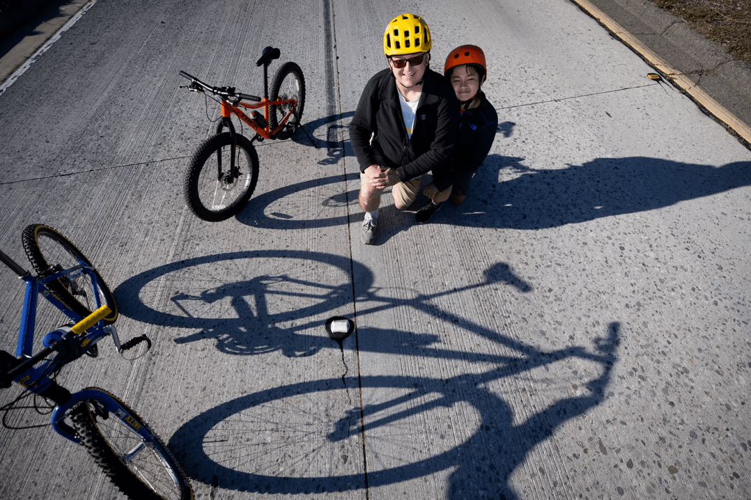 Bikers sitting on the ground for a break after cycling on the freeway