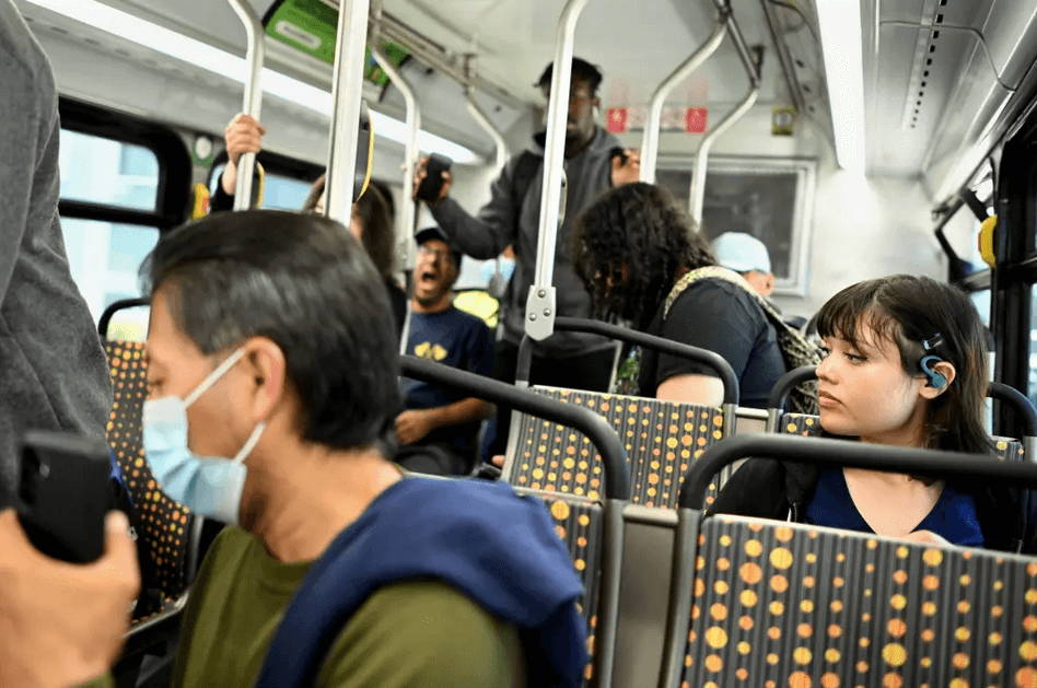 Masked riders ride the Los Angeles bus